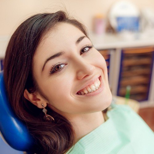 Woman in dental chair smiling