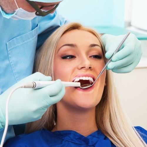 Dentist using intraoral camera to capture smile images