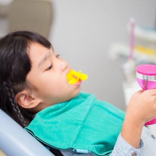 Child receiving fluoride treatment