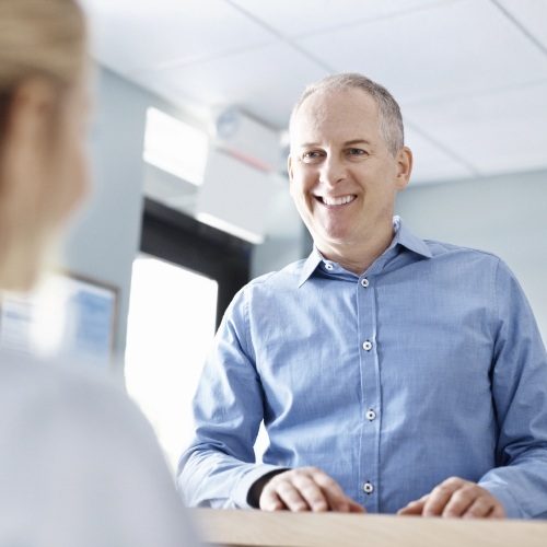Dental team member explaining the cost of dental implants