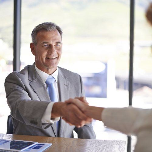 Man shaking hands with dental team member