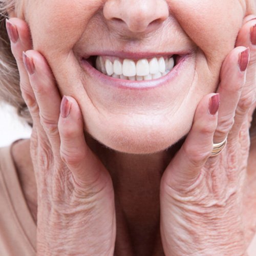 closeup of woman smiling after getting dentures 