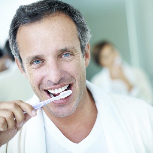 Man brushing teeth to prevent dental emergencies