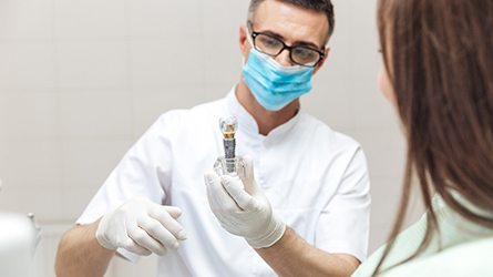 Dentist discussing dental implant with female patient