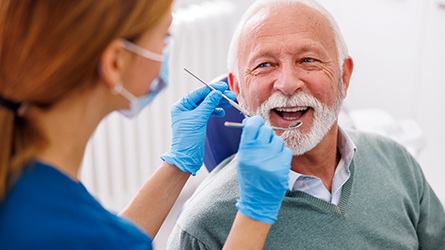 Mature man smiling during dental checkup 