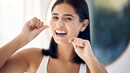 Woman smiling while eating healthy meal at restaurant