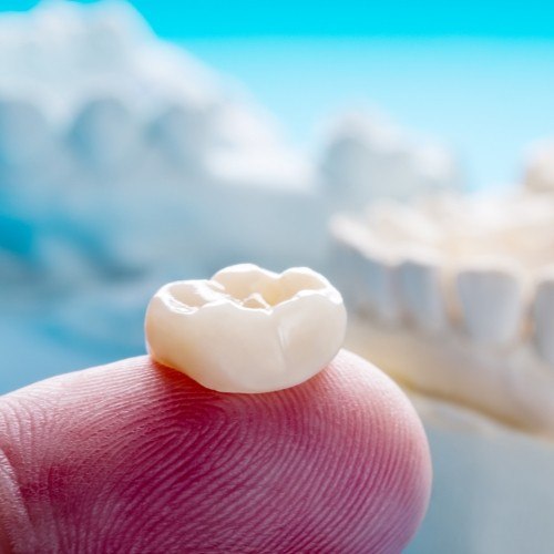 Dental crown on fingertip