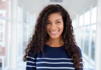 Young woman with healthy smile after preventive dentistry