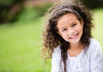 Young dental patient smile after visiting her children's dentist