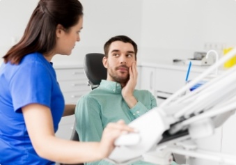 Man holding cheek before replacing missing teeth