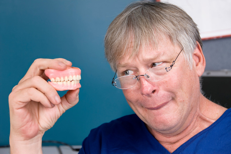 Patient checking out their ill-fitting dentures